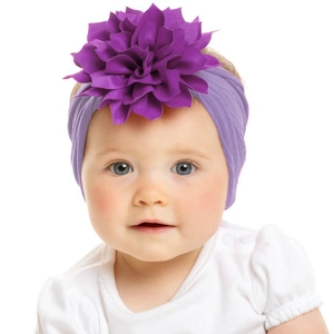 Elastic nylon baby headband with a large layered purple flower on an infant model