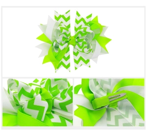 Detail of neon green and white chevron layered bow hair clip with metal alligator grip