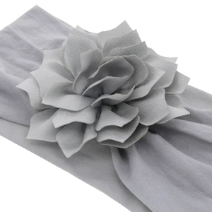 Light gray elastic nylon baby headband featuring a large ruffled fabric flower accessory