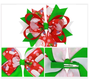 Detail view of handmade Christmas hair clip with Santa patterns and green metal duckbill clip
