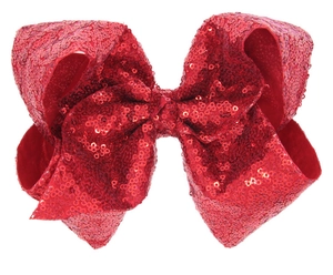 Détail du nœud papillon à paillettes rouges montrant la texture scintillante et le soin