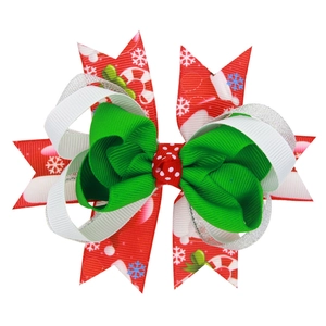 Christmas bow hair clip with red holiday patterns, green ribbon and silver glitter layers