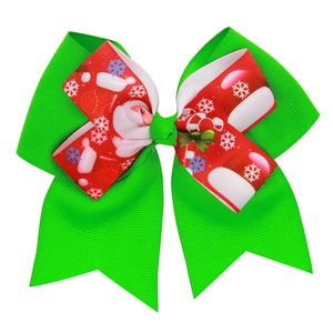 Christmas bow hair clip with Santa pattern and green ribbon on a white background