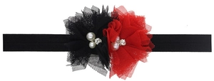Détail d'un bandeau bébé avec fleurs en dentelle rouge et noir, perle et strass au centre