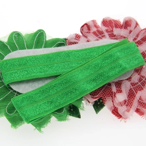 Handmade elastic infant headband with green and pink fabric flowers and soft felt backing