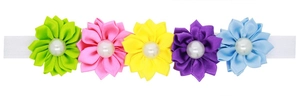 Détail d'un bandeau à fleurs en satin coloré avec perles blanches pour bébés