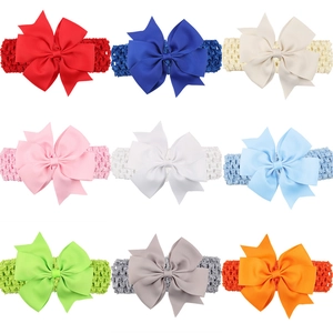 Set of 9 elastic baby headbands with large ribbed bows in various solid colors