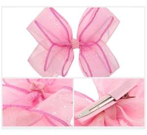 Detail view of pink sheer mesh hair bow with silver sequins and metal duckbill clip