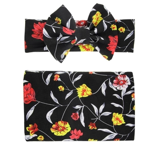 Detail of floral baby swaddle blanket and headband set with red and yellow roses
