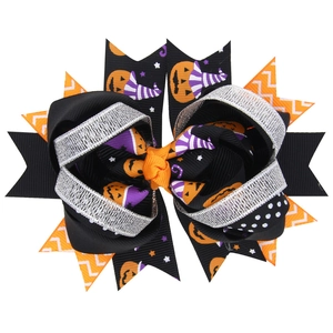 Halloween layered hair bow with pumpkin and bat prints in orange, black and purple