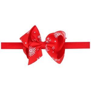 Red Christmas bow headband with white snowflake patterns for baby girls and infants