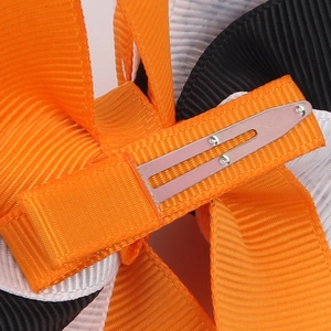 Halloween swallowtail bow hair clip with orange and black ribbons on a silver metal clip