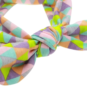 Close-up of baby headband with geometric triangle print and soft knotted fabric detail