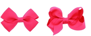 Detail of rose red grosgrain ribbon bow hair clips showing textured ribbing and layered design