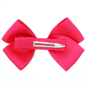 Detail of hot pink grosgrain ribbon bow hair clip with metal alligator grip back