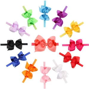 Top-down view of 12 colorful 12cm grosgrain ribbon bow headbands for baby girls