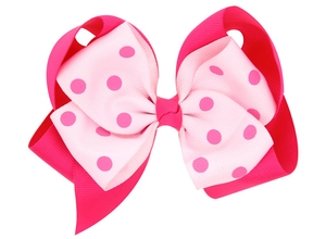 Close-up of double layer grosgrain ribbon hair bow with pink polka dot pattern