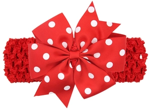 Détail du nœud en gros-grain à pois rouges sur bandeau élastique au crochet pour bébé