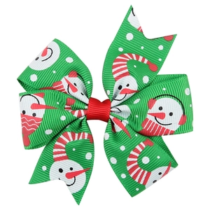 Detail shot of green Christmas snowman print bow clip with red ribbon knot for girls