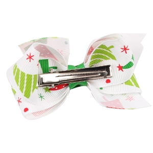 Detailed view of Christmas bow hair clip with tree print and metal alligator clip