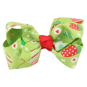 Handmade Christmas bow hair clip with festive patterns on green grosgrain ribbon
