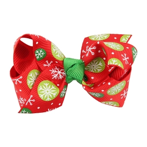 Christmas hair bow for kids with red ribbon featuring snowflake and polka dot patterns