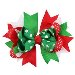 Handmade red and green Christmas bow hair clip with polka dot grosgrain ribbon patterns
