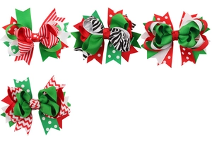 Set of four layered Christmas grosgrain hair bows with festive patterns in red, green and white