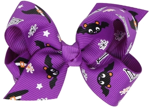 Detail of Halloween hair bow in purple grosgrain ribbon with bat and witch hat prints