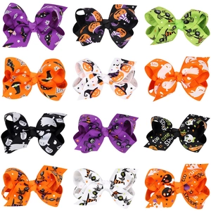 Detailed grid of 12 Halloween hair bows featuring pumpkin, ghost and bat printed patterns