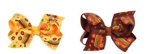 Detailed close-up of Halloween bows with pumpkin prints and high-density grosgrain fabric