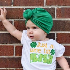 Detail of St. Patrick's Day baby knot headband and clover embroidered tshirt set