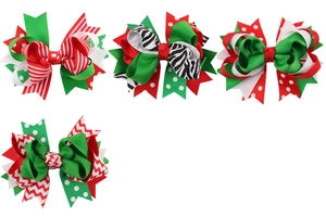 Set of four handmade Christmas bow hair clips in festive red, green and white ribbon