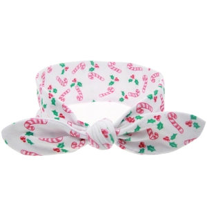 Detail of Christmas headband with holiday candy cane and holly leaf prints on white fabric