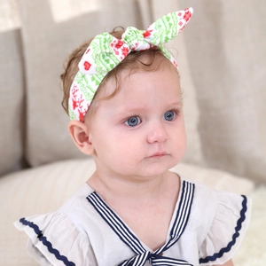 Baby Christmas headband featuring reindeer and heart patterns with a festive bow knot