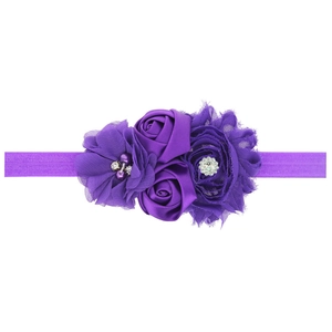 Elastic baby headband with purple sunflower fabric blossoms, pearls and shiny rhinestones