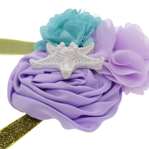 Baby starfish headband with purple and blue floral details on a gold glitter elastic strap