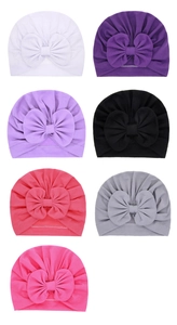 Detailed grid view showing seven colors of baby turban hats with large soft bow accents