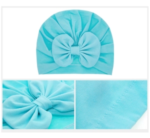 Detailed view of lake blue baby turban hat with large bow and premium knit fabric texture
