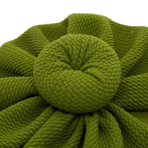Green infant turban hat with waffle texture and 3D donut knot on white background