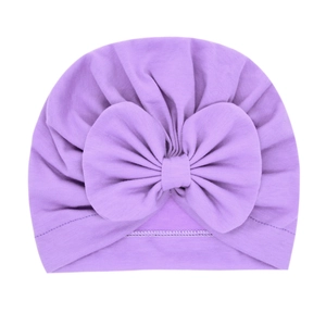 Soft purple newborn turban hat with large bow made of elastic knitted cotton fabric