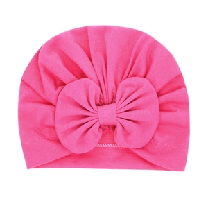 Rose red baby turban hat with a large bow detail made of soft knitted cotton fabric