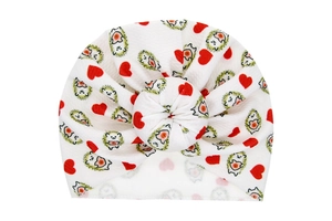 Close-up of white baby donut turban with waffle texture and cartoon hedgehog print