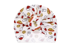 Detailed view of white baby turban hat with festive Christmas print and donut knot