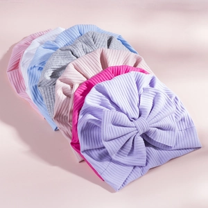 Detail of ribbed knit baby hats with large bow accents in seven assorted colors