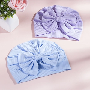 Detail of ribbed cotton baby turbans in light purple and blue with large bows