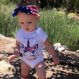 Detail of baby unicorn romper with American flag headband for Independence Day outfit