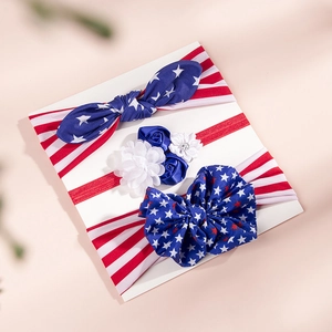Close-up of patriotic infant headbands featuring stars, stripes, and floral accents