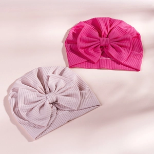 Detailed close-up of ribbed texture and oversized bow on soft cotton baby turbans