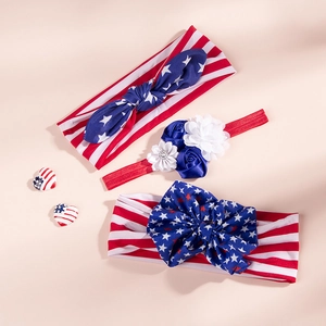 Detailed view of three soft July 4th headbands with red, white and blue bows and flowers